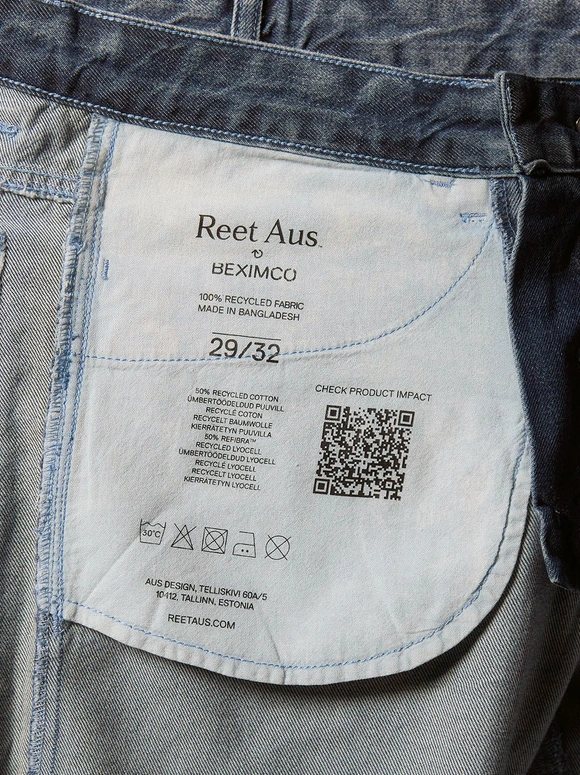 Denim garment label with environmental impact information and a QR code