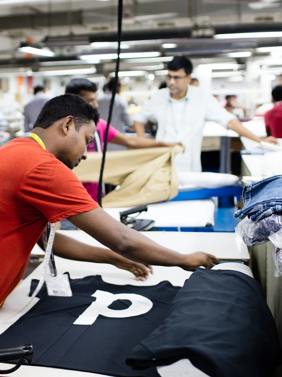 Garment workers producing clothing on a factory floor